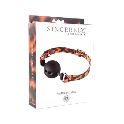 Sincerely Amber Luxury Ball Gag with gold accents on a black background.
